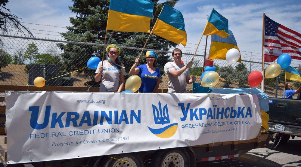 Staff wave Ukrainian flags during parade