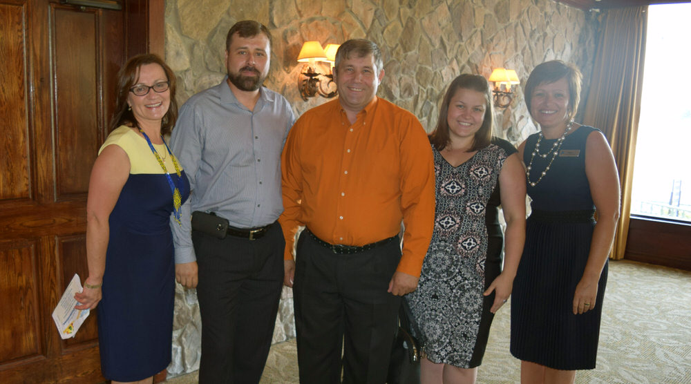 Local community leaders smile with UFCU staff at a dinner event