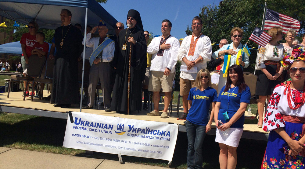 Staff stand by podium at conclusion of parade route