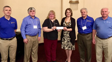 UFCU management and board of directors presents donation check