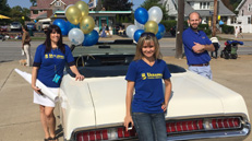 UFCU staff with parade vehicle