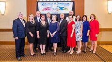 Group of people posing in front of a banner