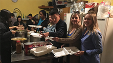 Two women helping serve food