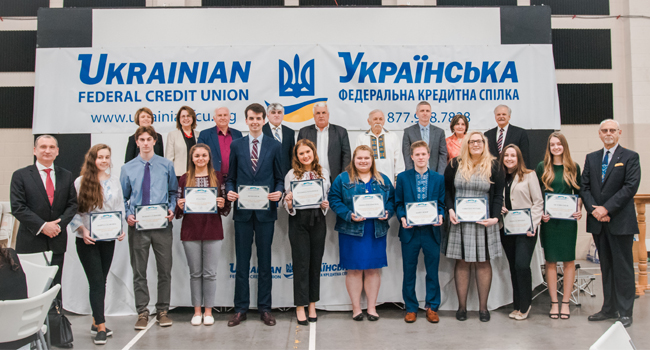 group of students standing with certificates