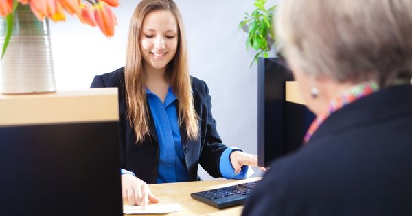 Woman is serving old lady